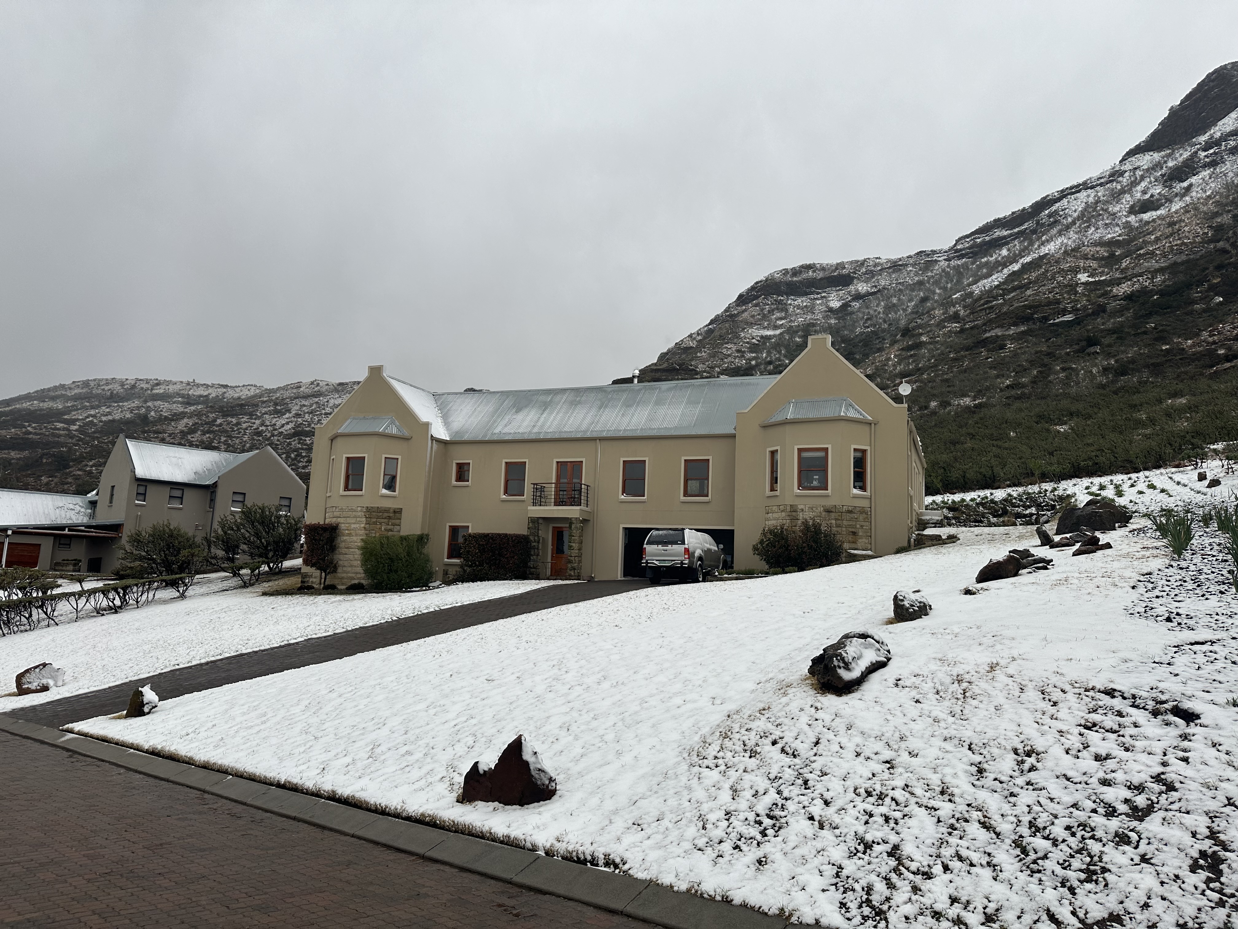 Snow on estate houses, winter at Clarens Mountain Estate